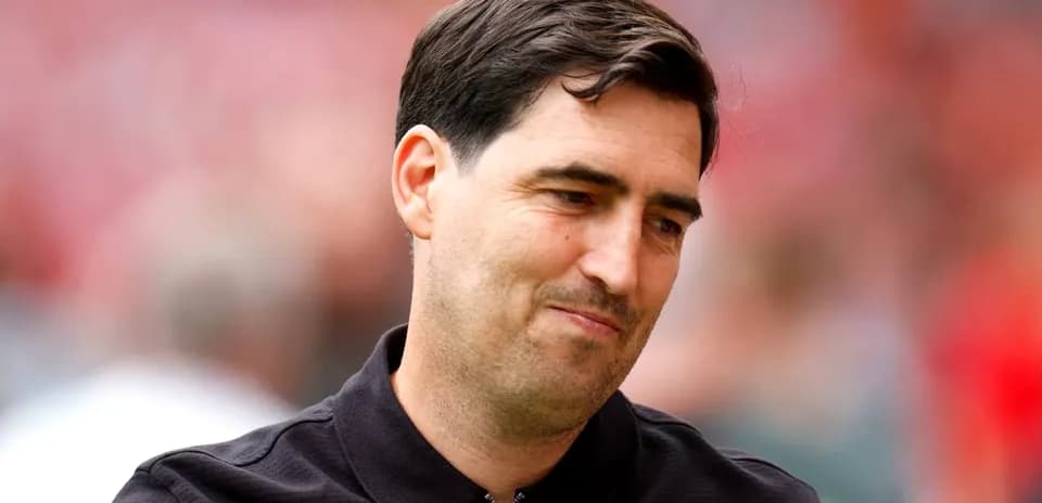 Coach with a slight smile during match day