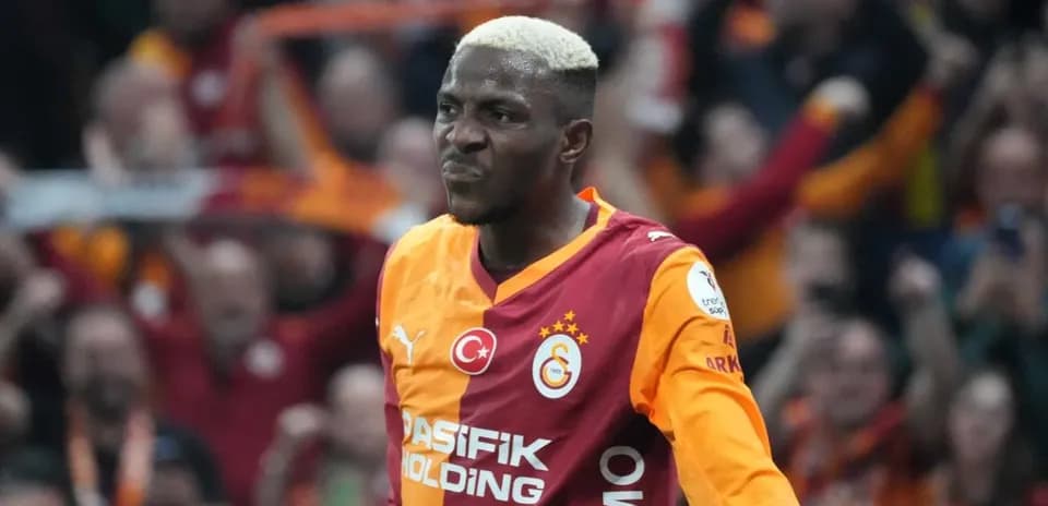 Galatasaray player celebrating a goal with fans
