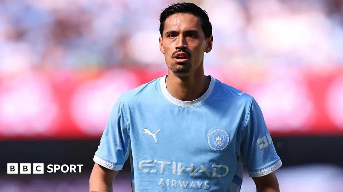 Player in light blue Manchester City jersey on field