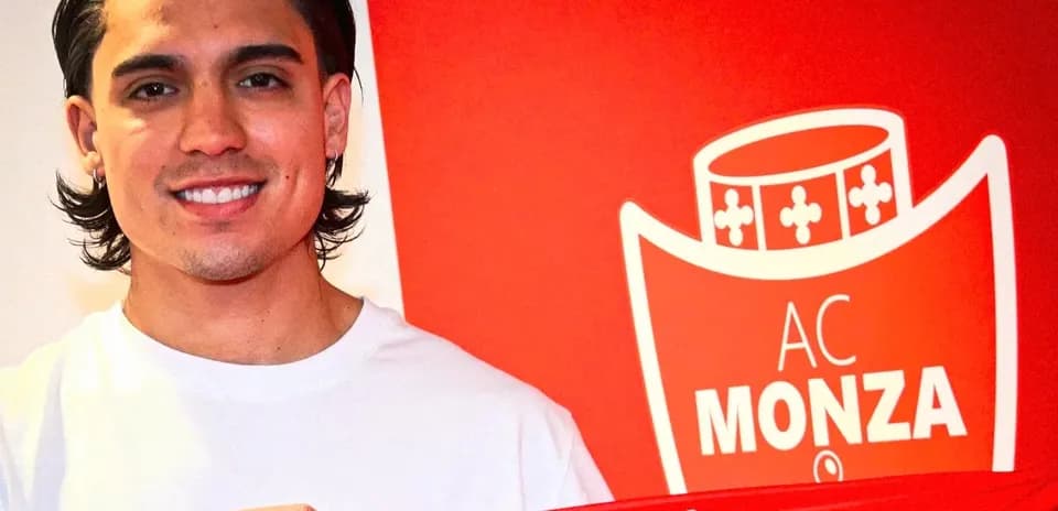 Player holding AC Monza jersey at signing event