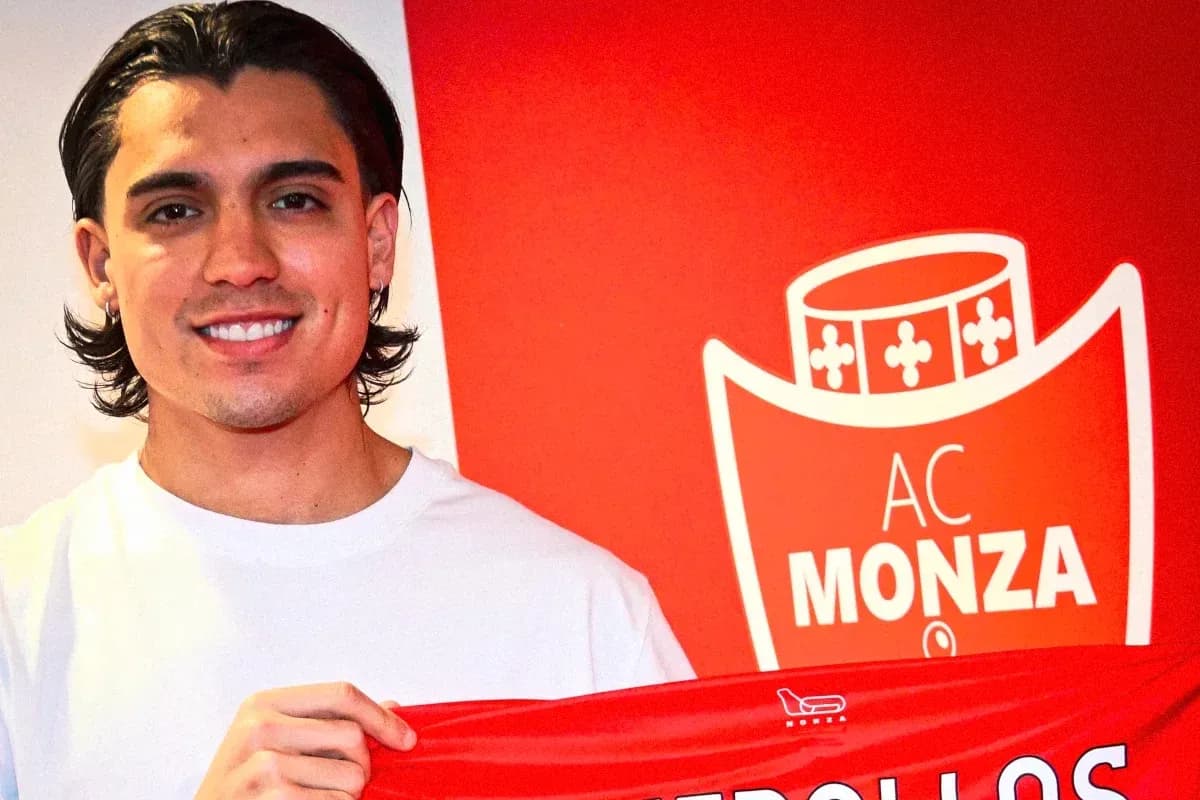 Player holding AC Monza jersey at signing event