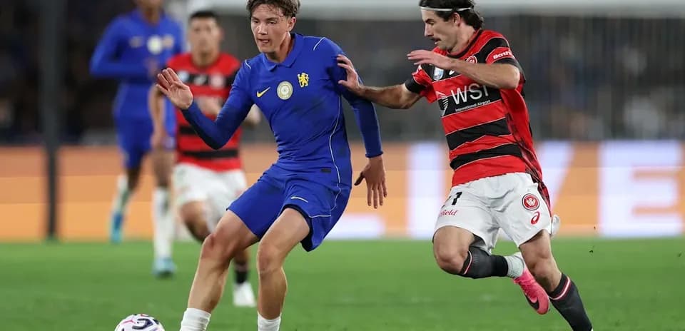 Player in blue dribbling while being challenged by opponent