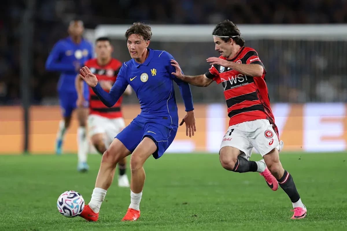 Player in blue dribbling while being challenged by opponent