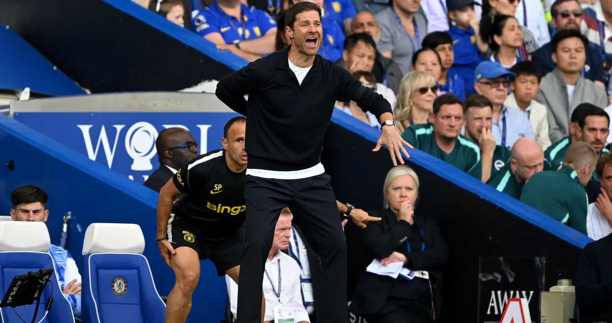 Coach gesturing from the sidelines during a match