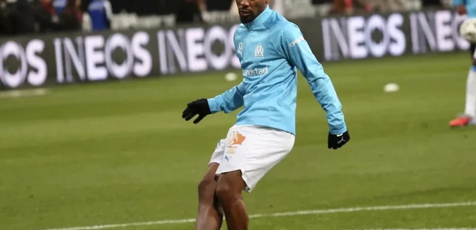 Player warming up on pitch before match