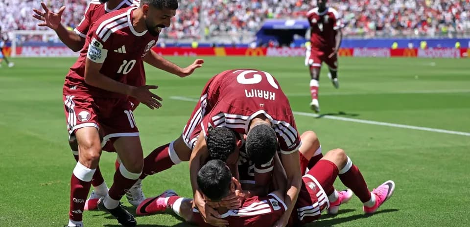Qatar players celebrating a goal on the field