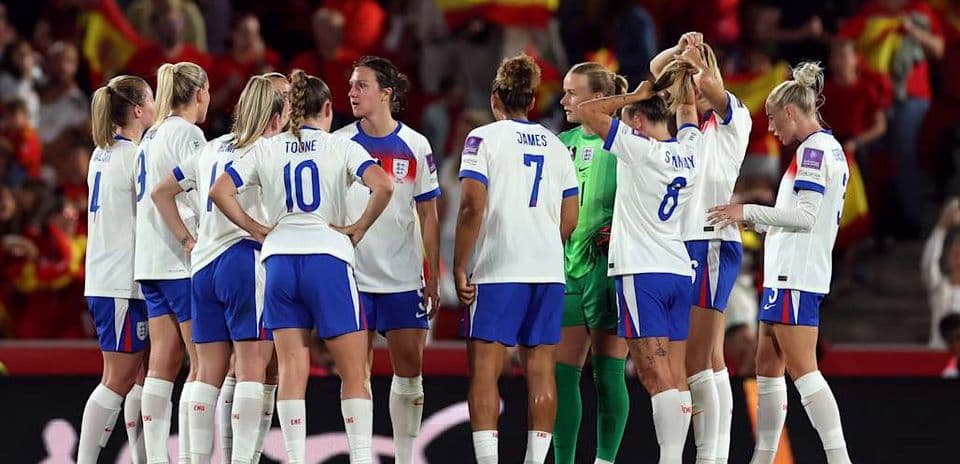 England women's team huddled during a match