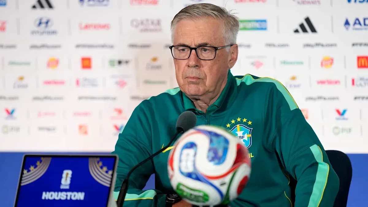 Coach at press conference with soccer ball in foreground