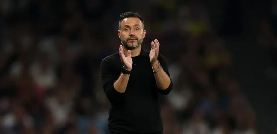 Coach applauding during a match on the sidelines