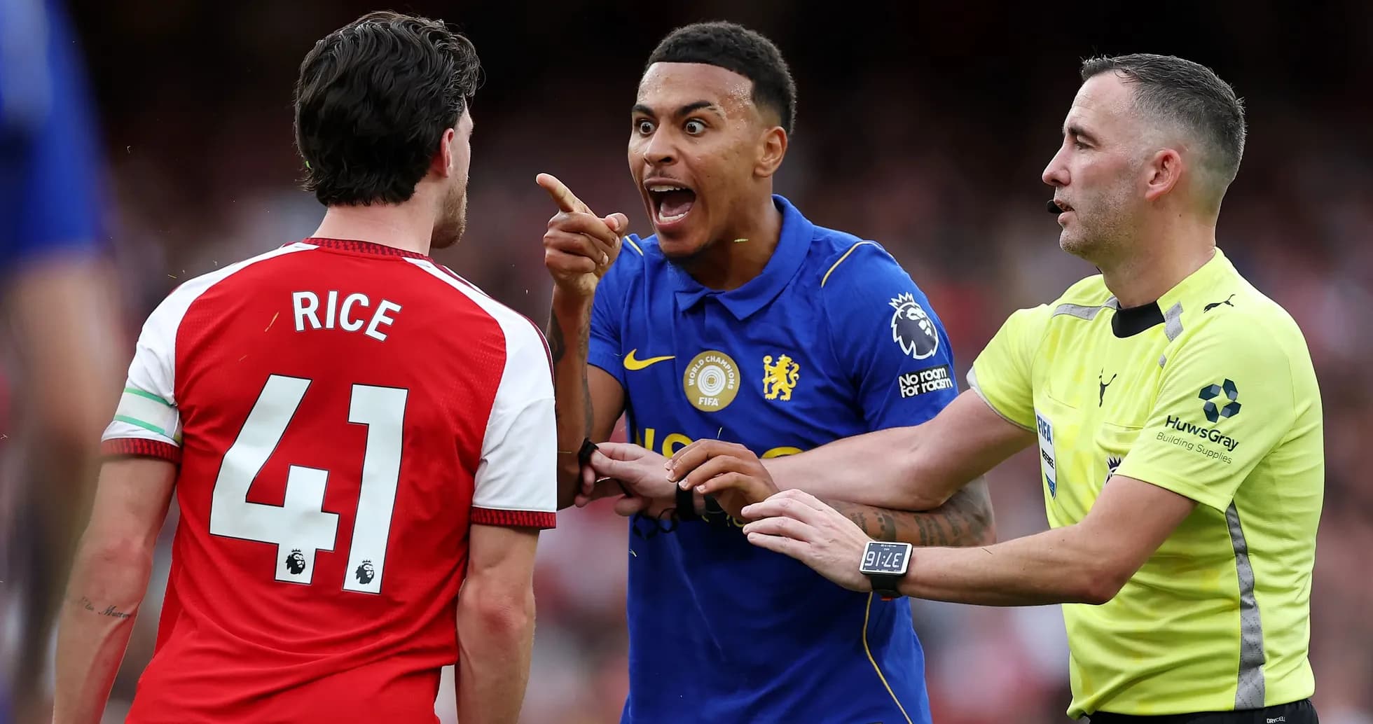 Players arguing during a match, referee intervening