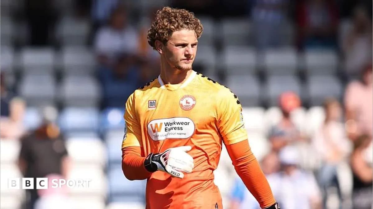 Goalkeeper in orange kit preparing for match