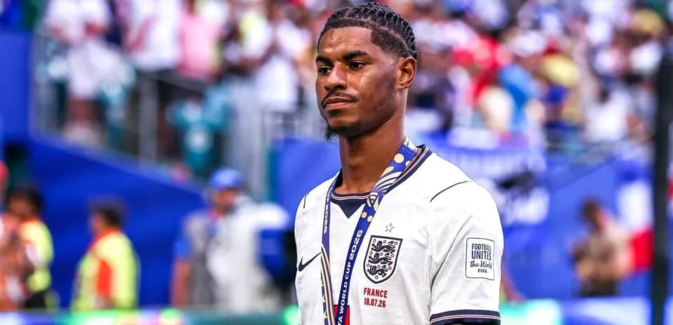 Player in England jersey wearing a medal after match