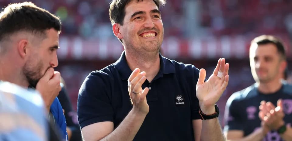 Coach applauding with players during match celebration