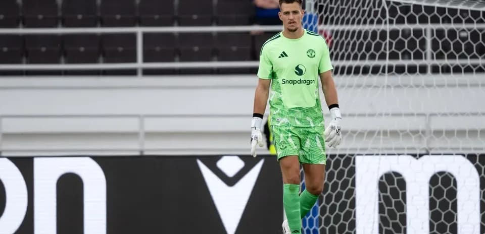 Goalkeeper in green kit standing in front of goal