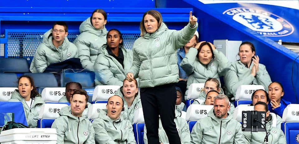 Coach directing players from the sidelines during match