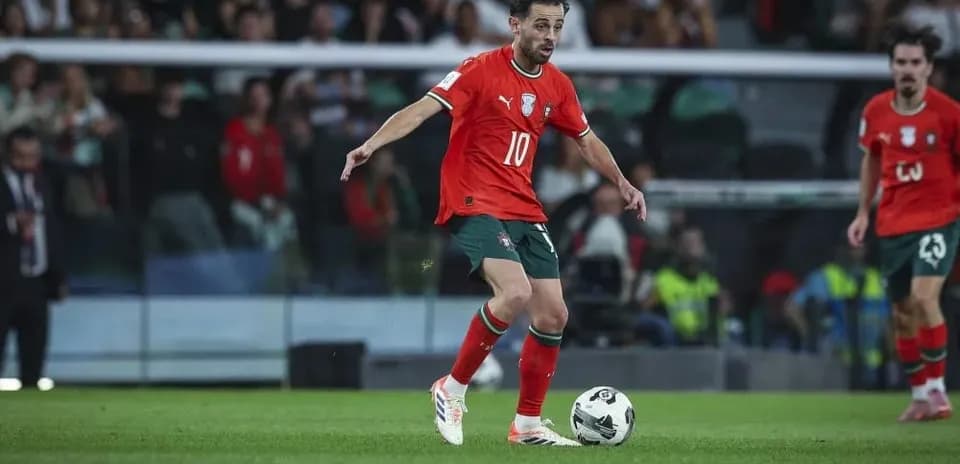 Player in red jersey controlling the ball on field