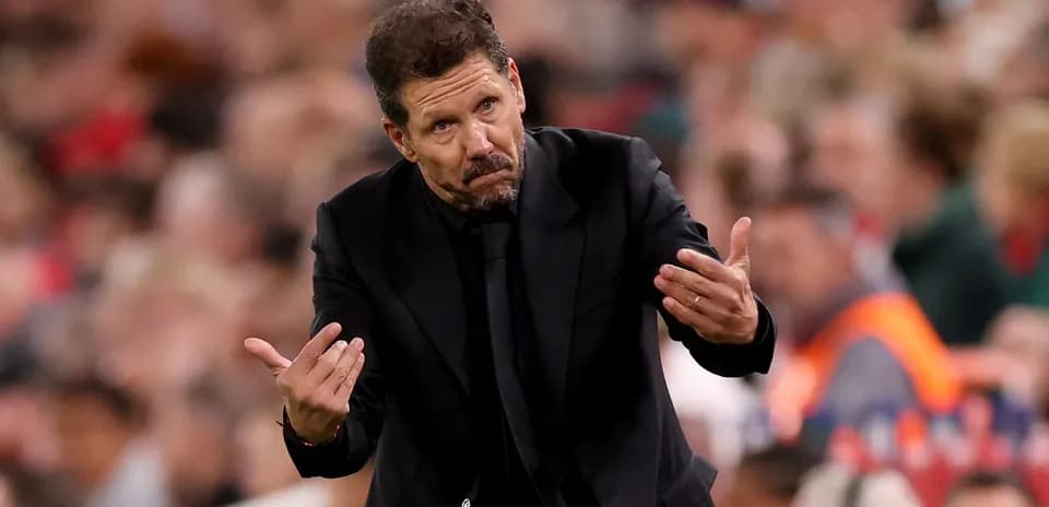 Manager gesturing on the sidelines during match
