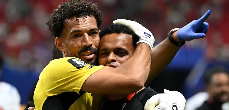 Goalkeeper celebrating with coach after match