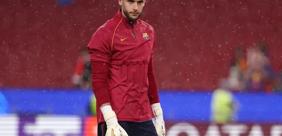 Goalkeeper in training gear during rainy warm-up