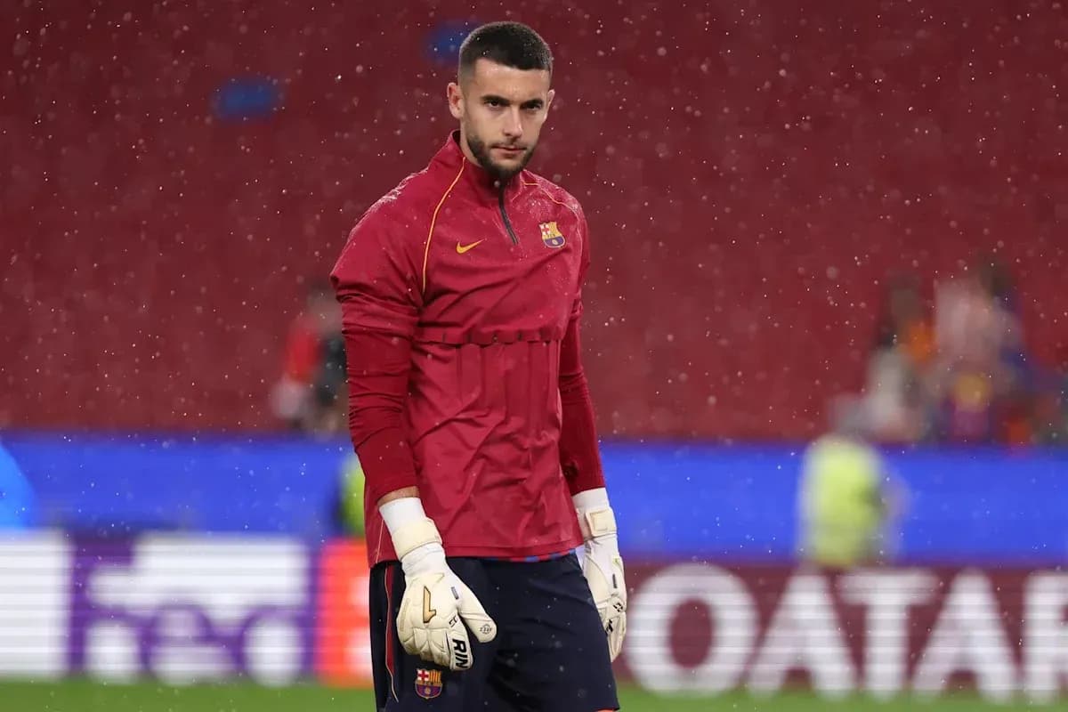 Goalkeeper in training gear during rainy warm-up