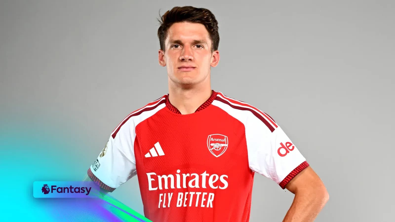 Player posing in Arsenal jersey with sponsor logos