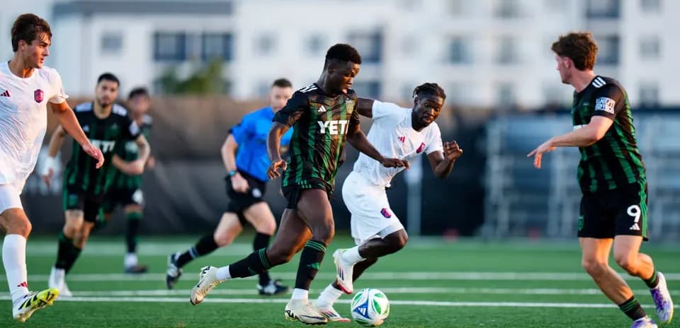 Players competing for the ball during MLS Next Pro match