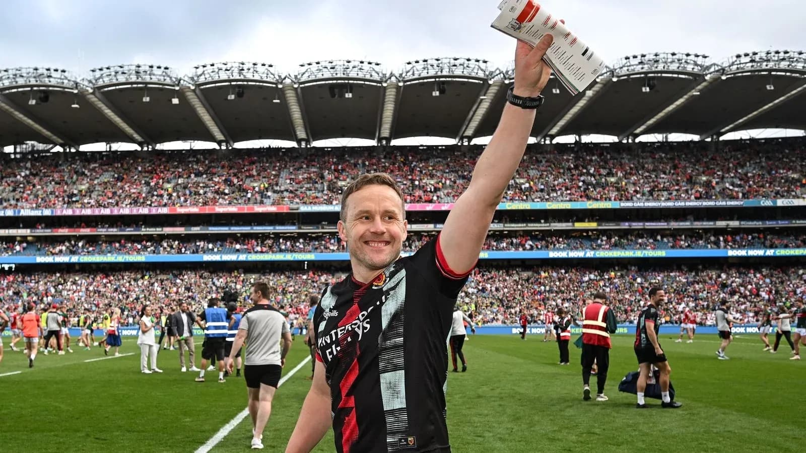 Player celebrating with fans in packed stadium
