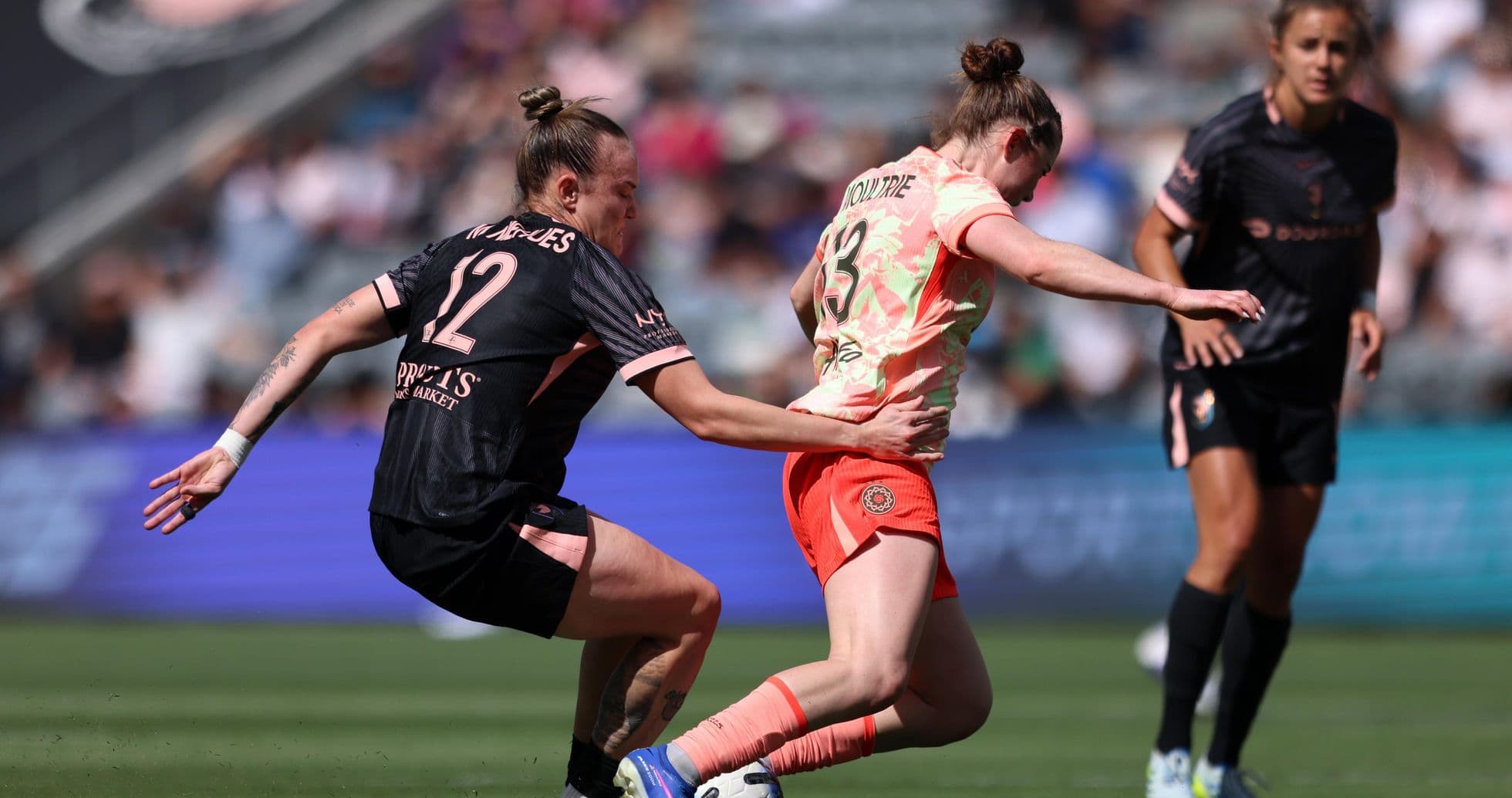 Players competing for the ball during NWSL match