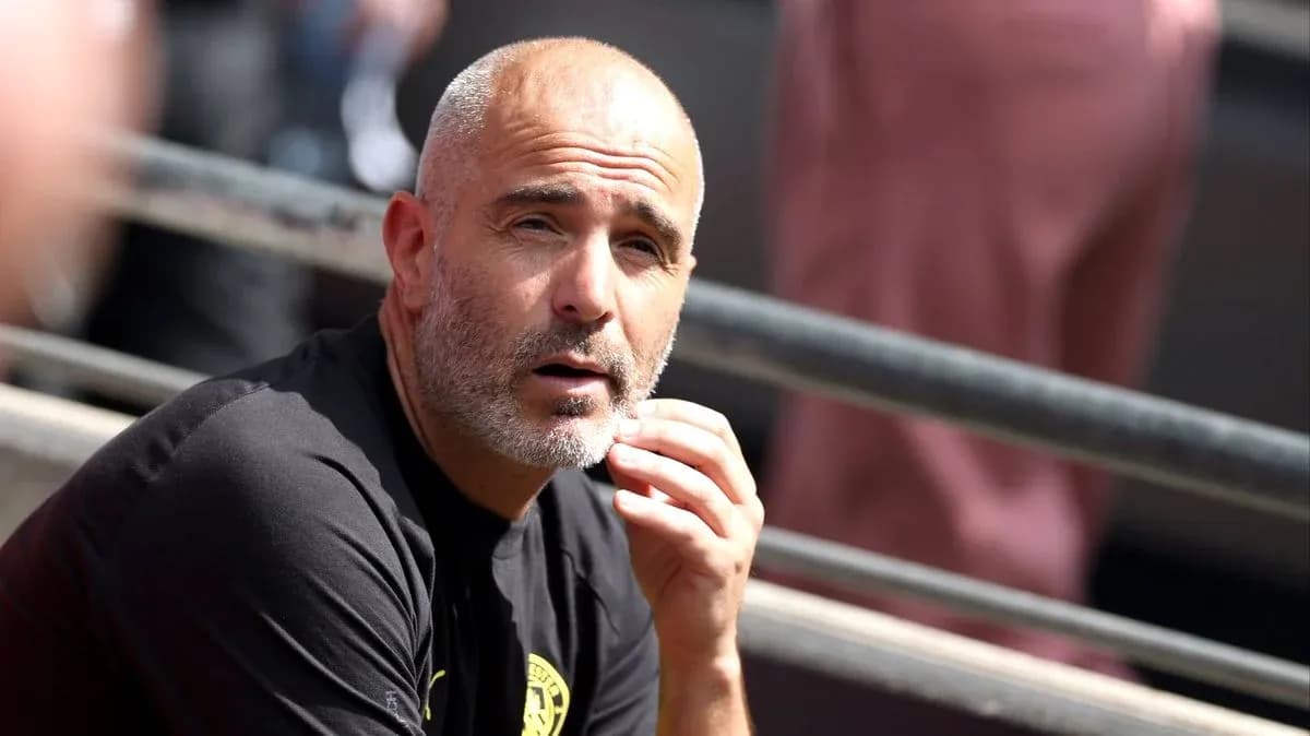 Coach sitting pensively on the sidelines