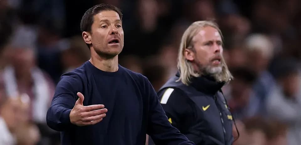 Coaches gesturing during a match on the sidelines