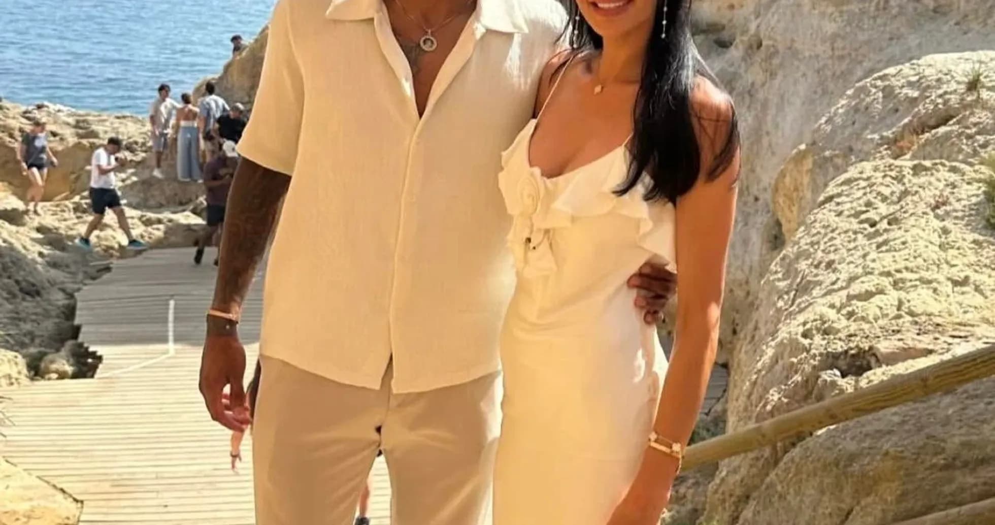 Couple posing on a beachside pathway