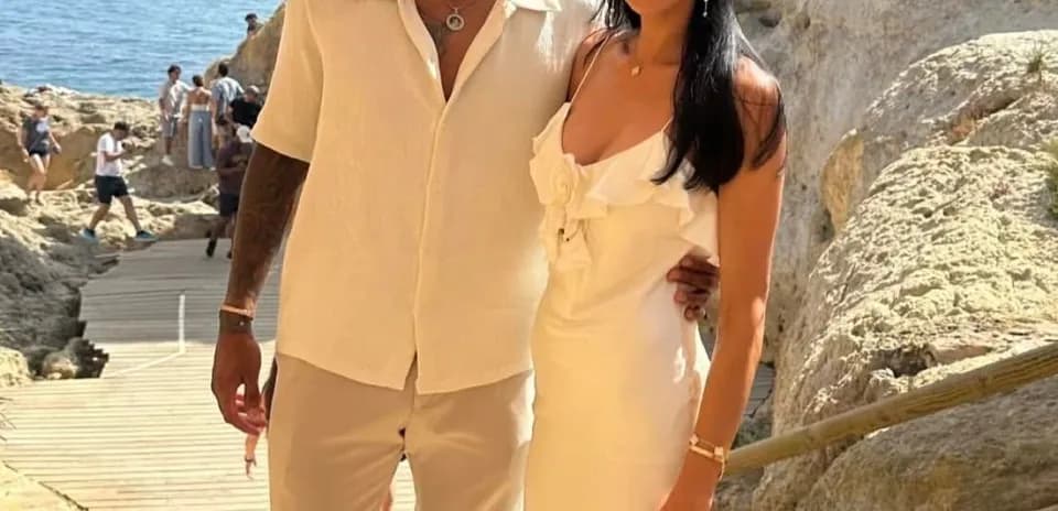 Couple posing on a beachside pathway