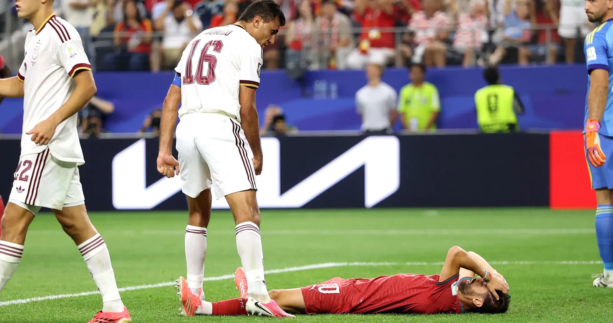 Player lying on ground with teammates nearby