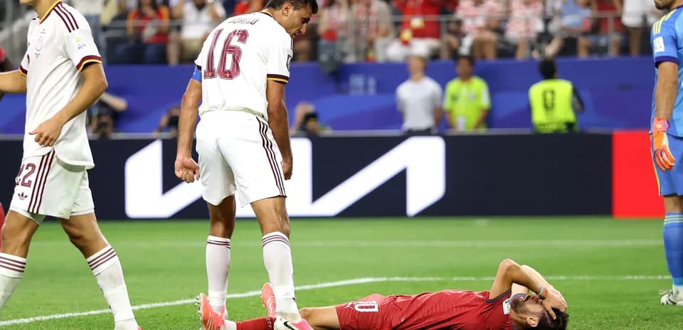 Player lying on ground with teammates nearby