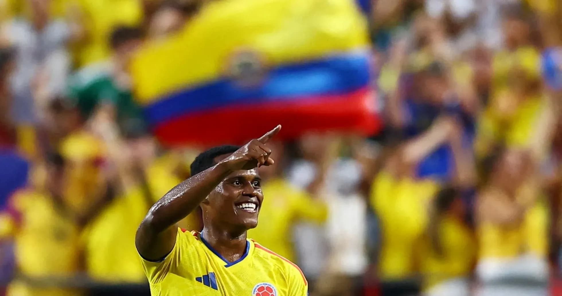 Player celebrating goal with fans in background