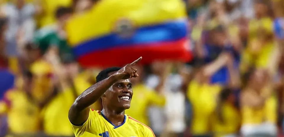 Player celebrating goal with fans in background