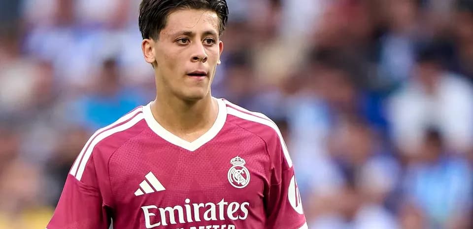 Player wearing pink Real Madrid jersey on field