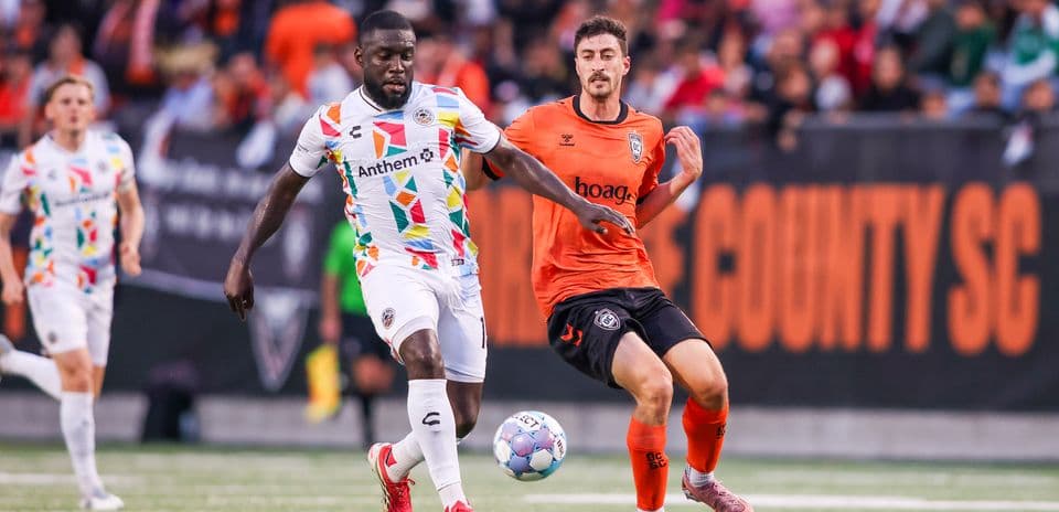 Players competing for the ball during USL match