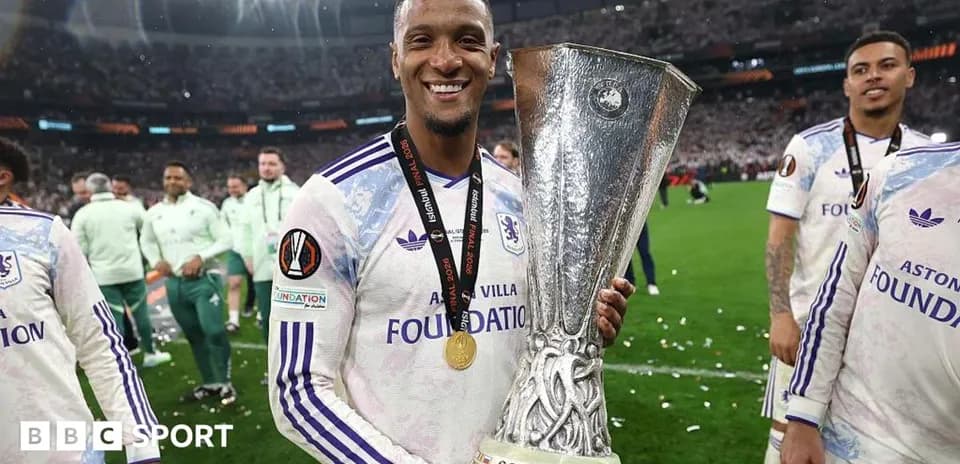 Player celebrating with UEFA trophy after winning match