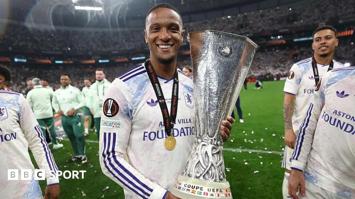 Player celebrating with UEFA trophy after winning match