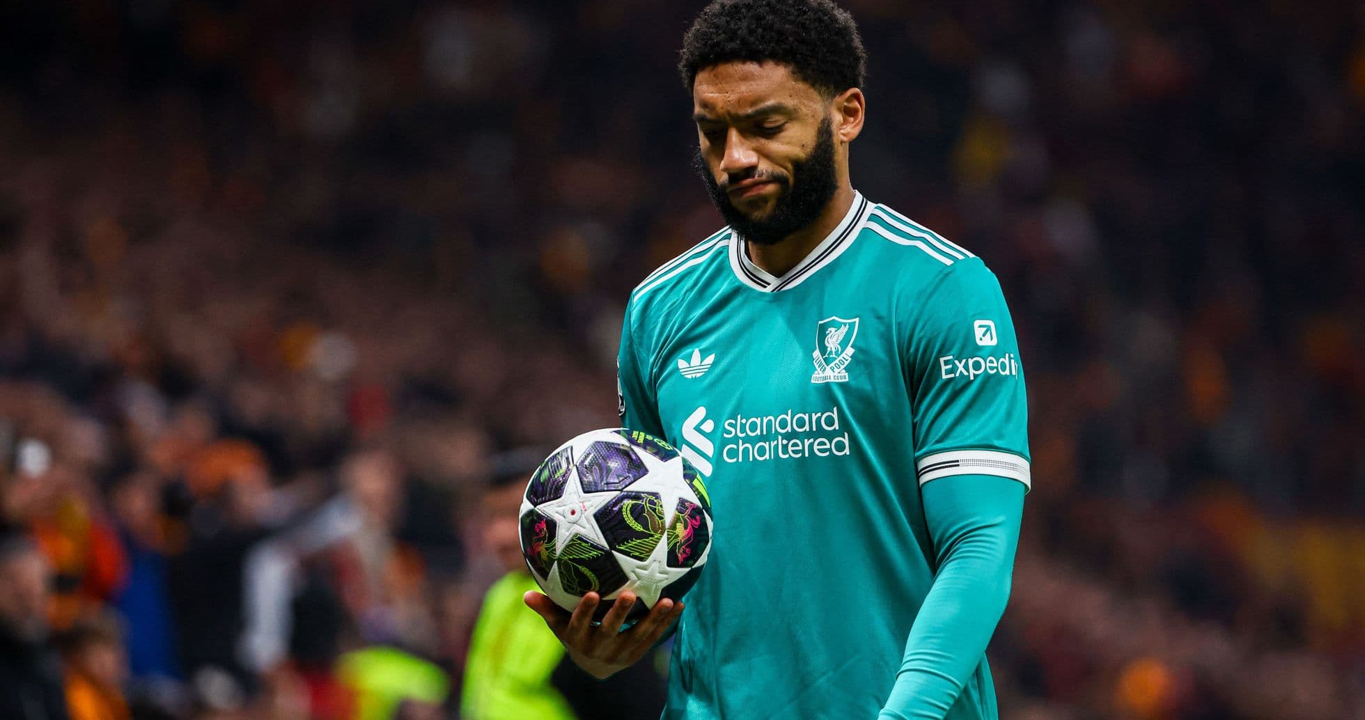 Player holding ball during match with crowd in background