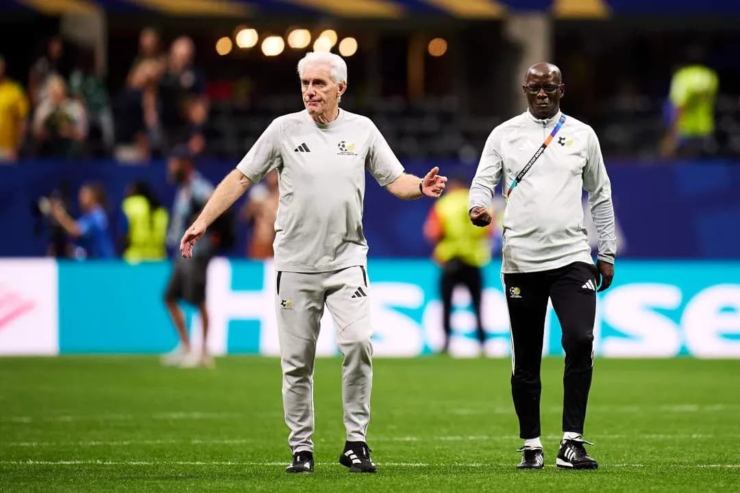 Coaches walking on the pitch during warm-up
