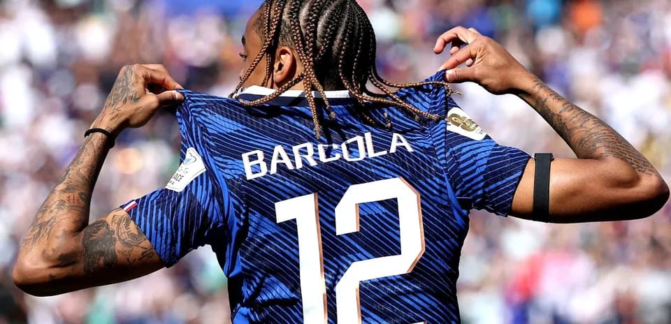 Player displaying jersey with name and number 12