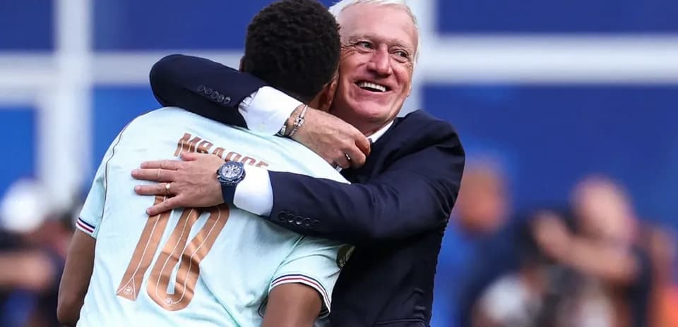 Player and coach embracing after match celebration