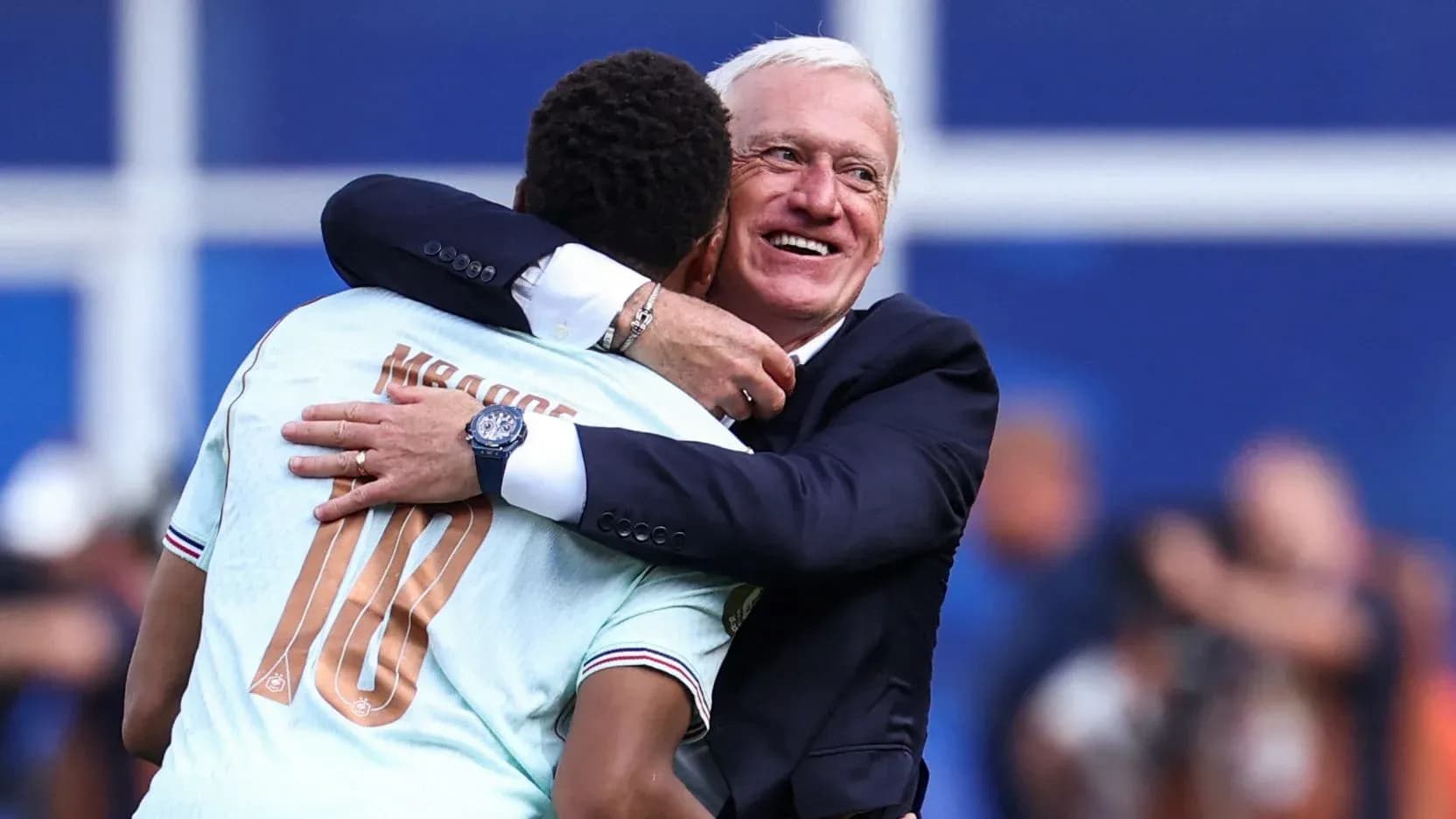 Player and coach embracing after match celebration