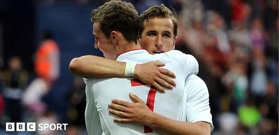 Two players embracing on the field after a match
