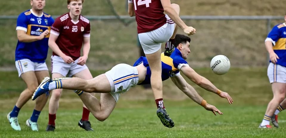 Player diving for the ball during Gaelic football match