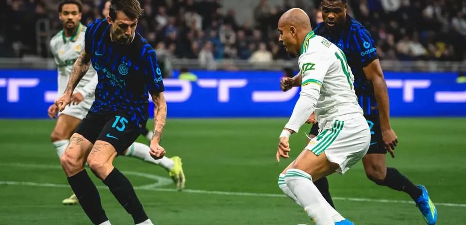 Inter player challenges AS Roma opponent for the ball