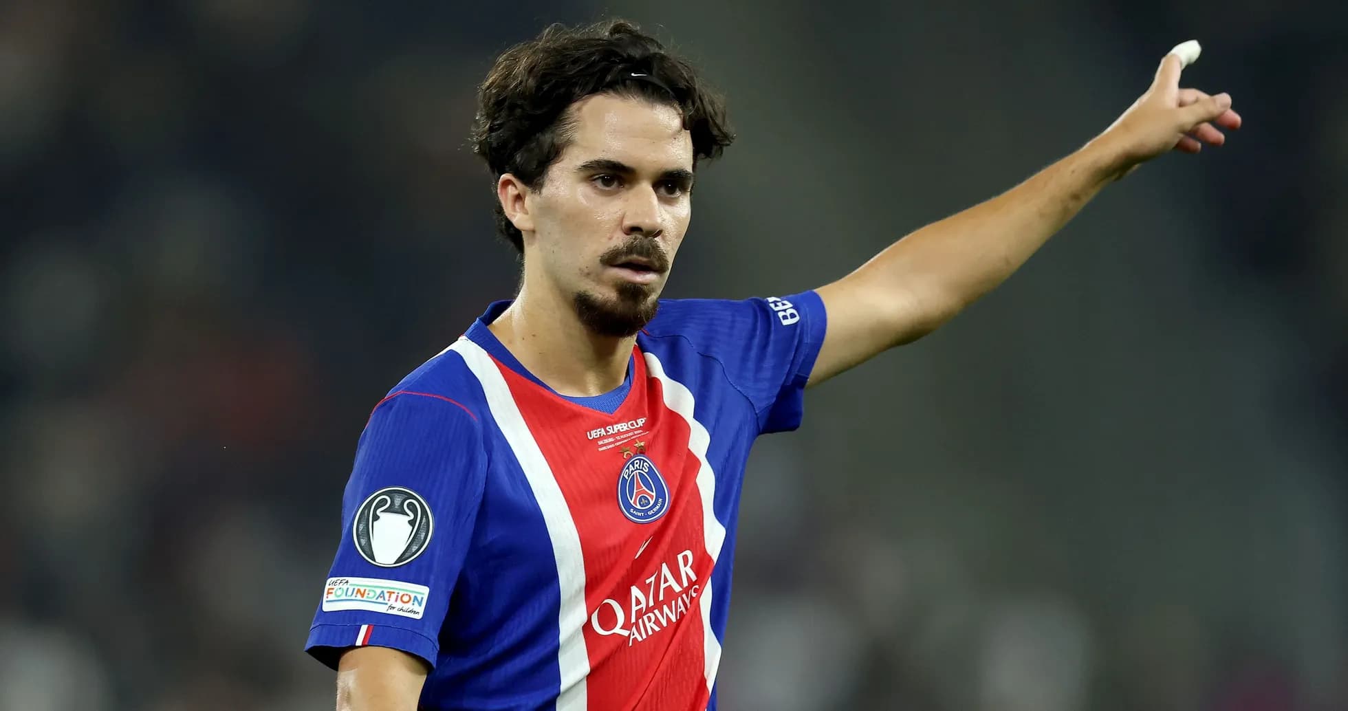 Player gesturing during a match in PSG jersey