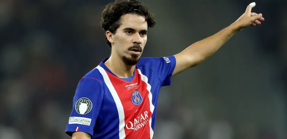 Player gesturing during a match in PSG jersey